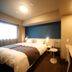Dormy Inn Miyazaki Natural Hot Spring guest room with double bed, desk, and TV in Miyazaki
