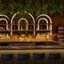 Moxy NYC Lower East Side bar with illuminated arches and hanging greenery in New York