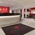 Ramada by Wyndham Wakefield lobby with front desk, modern seating area and branded entrance mat in Ossett