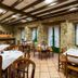 Hotel Villa de Cabrales in Las Arenas dining room with stone walls, wood beams and set tables