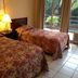 Gran Hotel Paris, La Ceiba: twin beds in a guest room with balcony doors and tropical view