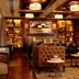 Westhouse Hotel New York lounge with tufted seating, warm lighting and shelves in New York
