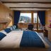 Hotel La Prairie in Crans-Montana room with balcony view of snowy mountains, blue curtains and wood paneling