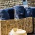 Vilanculos Beach Lodge in Vilanculos: wicker basket with rolled towels beside a poolside lounge area
