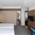 Green World Mai - Nanjing hotel room in Taipei City with twin beds, wood-paneled TV wall, and modern seating area