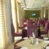 Asinuara Hotel Bahir Dar dining room with set tables and purple striped chairs
