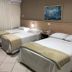 Hotel Steinhausen Blumenau guest room with three twin beds and tiled floor