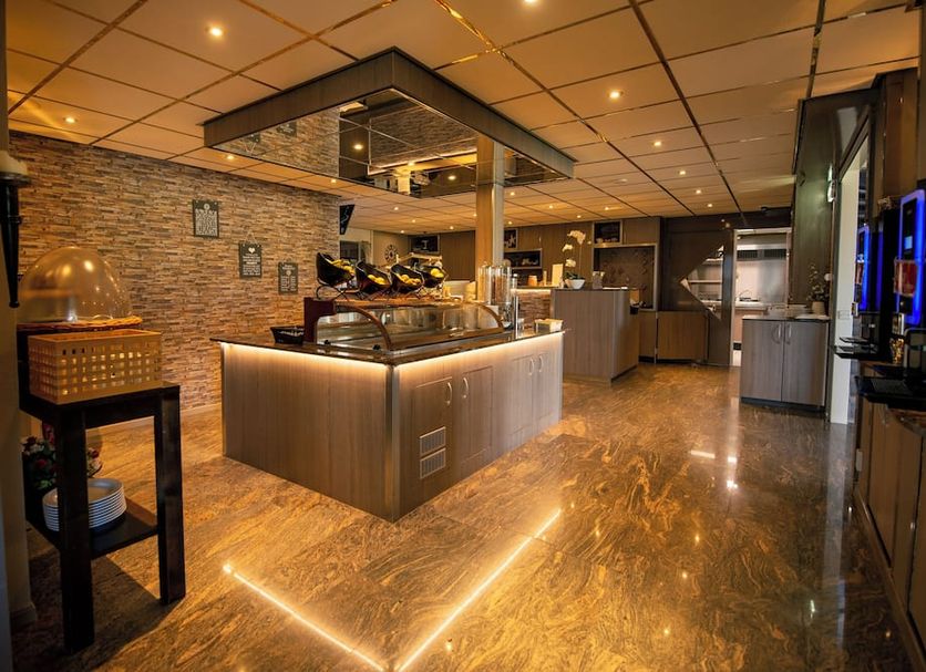 Hotel Restaurant 't Klokje in Renesse buffet restaurant interior with warm lighting and serving counter