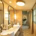 Hospes Las Casas del Rey de Baeza in Seville bathroom with double sinks, patterned tile floor and window