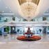 Haiqing Hotel Qingdao lobby with grand chandelier, central floral display and marble staircase