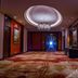 Hulunbeier Hotel in Hulunbuir corridor with chandelier, ornate ceiling, and patterned carpet