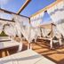 Agroturismo Es Quatre Cantons in Binissalem with white canopy daybeds and sheer curtains on a sunlit terrace