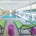 Home2 Suites by Hilton Saratoga Malta indoor pool with lounge chairs and large windows in Malta