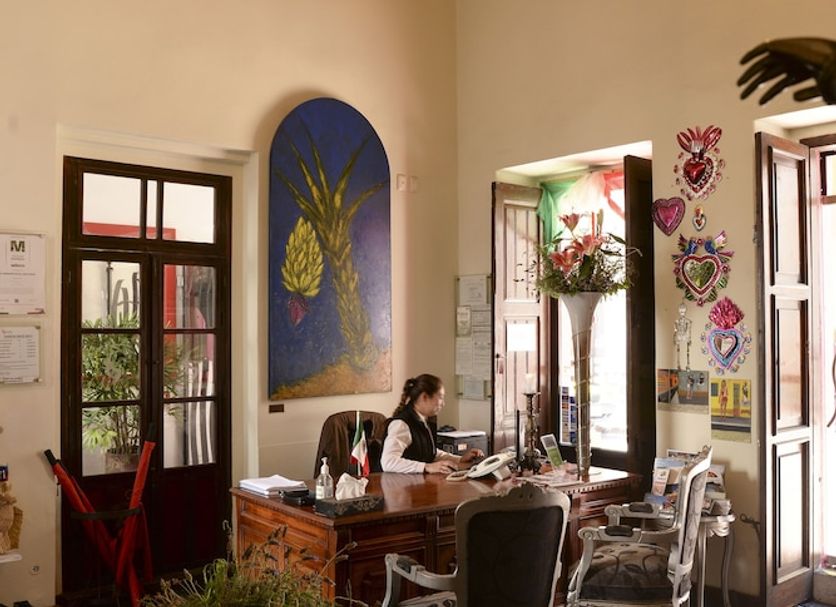 El Serafin Hotel Boutique in Santiago de Querétaro lobby with chandelier, high ceiling, and check-in desk