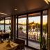 Kudo Hotel & Beach Club, Patong: beachfront restaurant with sunset ocean view through floor-to-ceiling windows