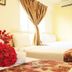 Sun Inns Hotel Lagoon in Petaling Jaya: twin beds with red flower towels and curtains by a bright window
