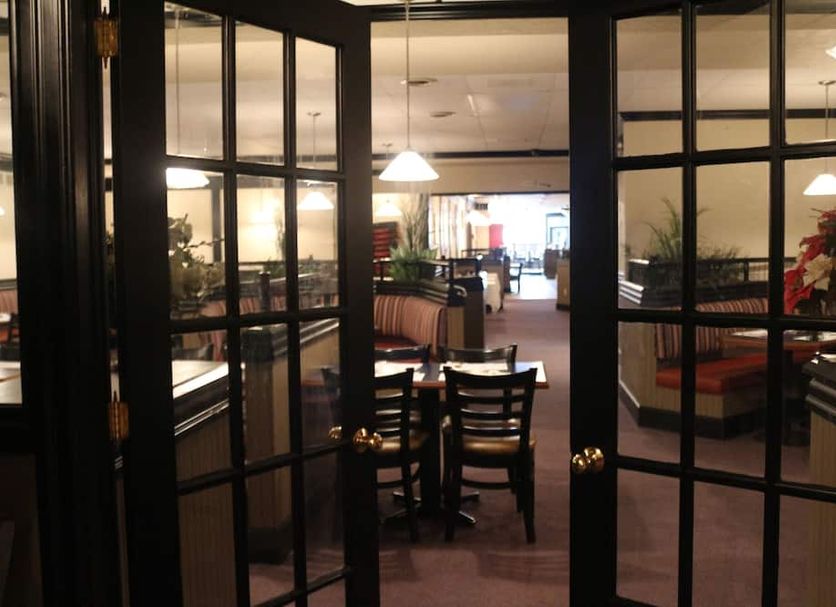 The Falls Family Lodge in Niagara Falls lobby entrance with dining tables and booths