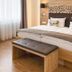 Waldhotel am Notschreipass room in Todtnau with a wood bed, bench, and wall lamps