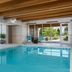 Home2 Suites by Hilton Idaho Falls indoor pool with lounge chairs and large windows