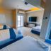 Brisa Marina Beach Resort powered by Cocotel in Morong room with three beds, TV and balcony view