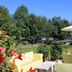 Airporthotel Salzburg outdoor garden terrace with yellow lounge chairs and umbrella