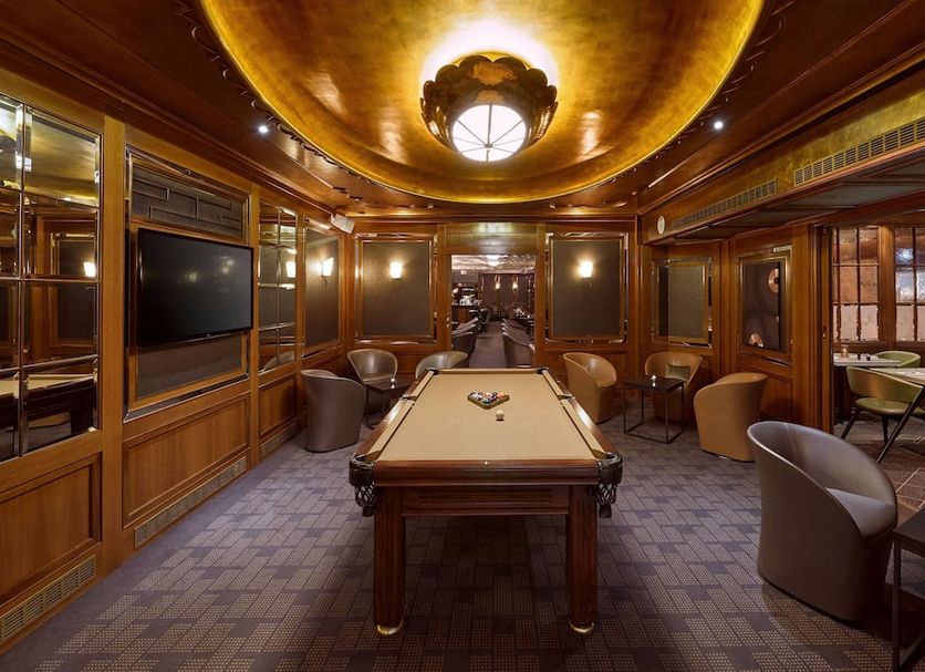 Reichshof Hotel Hamburg in Hamburg lounge with pool table, wood-paneled walls, and warm ceiling lighting