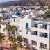Hotel Punta del Cantal in Mojacar with white buildings, blue domes, palm trees and mountain views