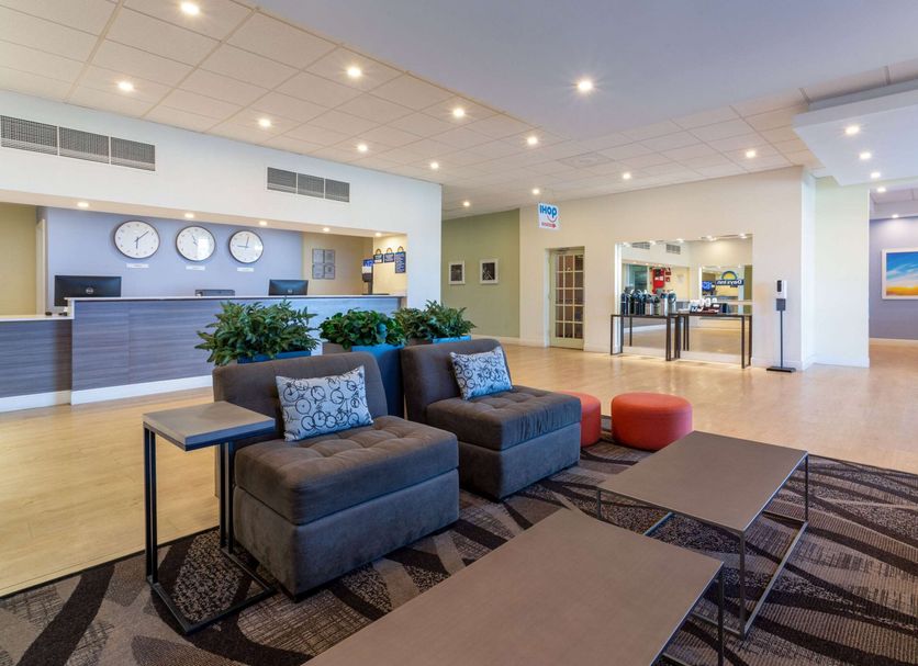 Days Inn by Wyndham Titusville Kennedy Space Center lobby with seating and front desk in Titusville