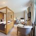 Bartley Lodge Hotel, Southampton: four-poster bedroom with seating area and large windows