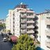 Vesta Apart Hotel in Kusadasi on a street beside nearby apartment buildings and trees