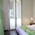 Hotel Casa de la Vega Bogotá guest room with double bed, balcony doors and turquoise door