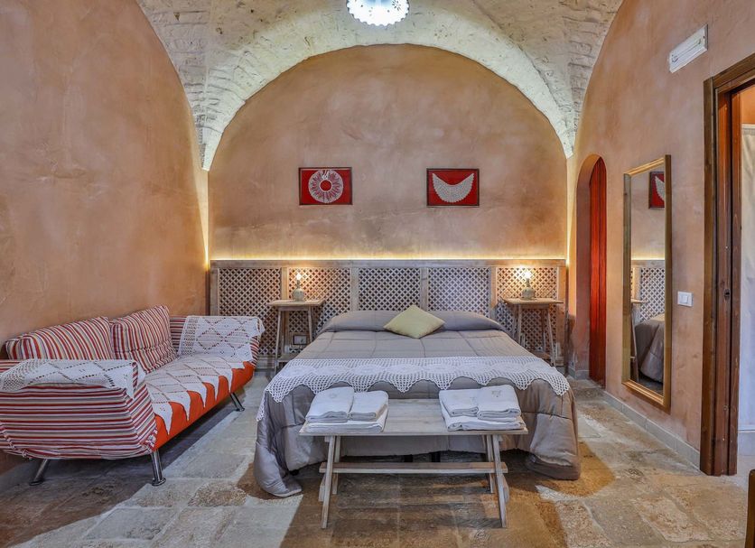 Masseria Casina Vitale in Ceglie Messapica with vaulted stone bedroom, double bed and daybed