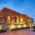 New Century Hotel Guian Guizhou in Anshun, illuminated brick building with arched windows at dusk
