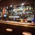 Tongadale Hotel in Portree bar with wooden counter, stools, and stocked backbar