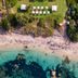 Hotel Cala Caterina in Villasimius with private beach, turquoise bay, and seaside lounge chairs