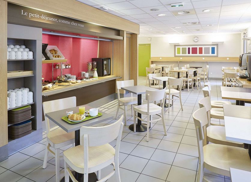 B&B HOTEL Lille Centre Grand Palais breakfast room with buffet and tables in Lille