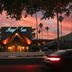Royal Sun Palm Springs hotel at sunset with illuminated entrance and palm trees in Palm Springs