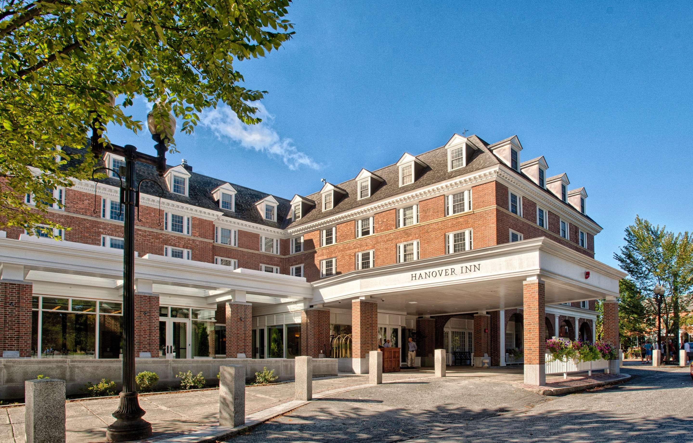 Hanover Inn Dartmouth in Hanover exterior with brick facade, covered entrance, and tree-lined street