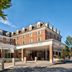 Hanover Inn Dartmouth in Hanover exterior with brick facade, covered entrance, and tree-lined street
