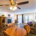 Timbers at Island Park living room with fireplace, sofa, coffee table, and balcony doors in Island Park