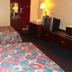 Executive Inn Rocky Top guest room with two double beds, TV, and bedside lamps