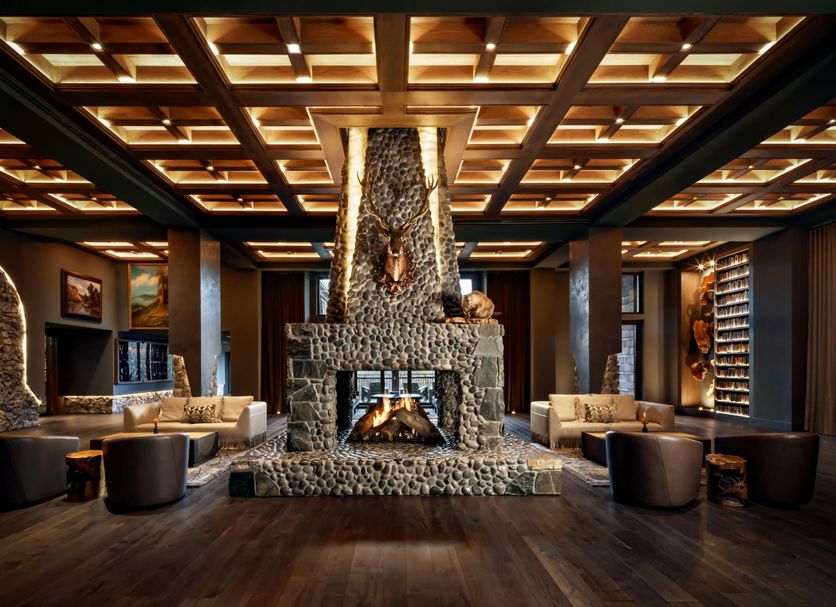 Grand Bohemian Lodge Greenville lobby with stone fireplace, wood ceiling, and lounge seating