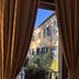 Hotel Villa Luppis in Pasiano di Pordenone, view through curtains of a courtyard and historic facade