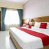 RedDoorz @ Seturan Raya 2 in Depok guest room with bed, desk, TV, and window curtains