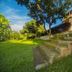 Hotel Royal Nest in Entebbe with garden steps leading to a yellow hotel building