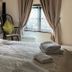 The Leather Bottle in Gravesend guest room with bed, armchair, and window with curtains