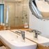 Best Western Plus Hotel Ostertor bathroom with double sink, large mirror and walk-in shower in Bad Salzuflen