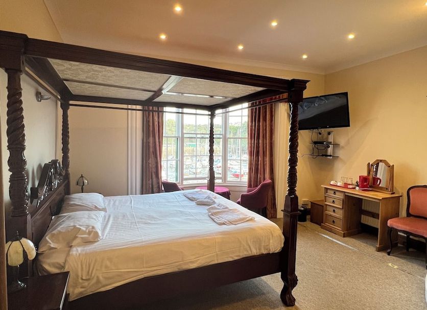 Royal Britannia Hotel in Ilfracombe guest room with four-poster bed, desk, chair and TV