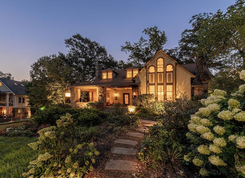 Stonehurst Place Bed & Breakfast in Atlanta, lit garden path leading to a charming historic inn at dusk