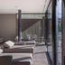 Klein Fein Hotel Anderlahn in Parcines lounge with chaise chairs beside floor-to-ceiling windows
